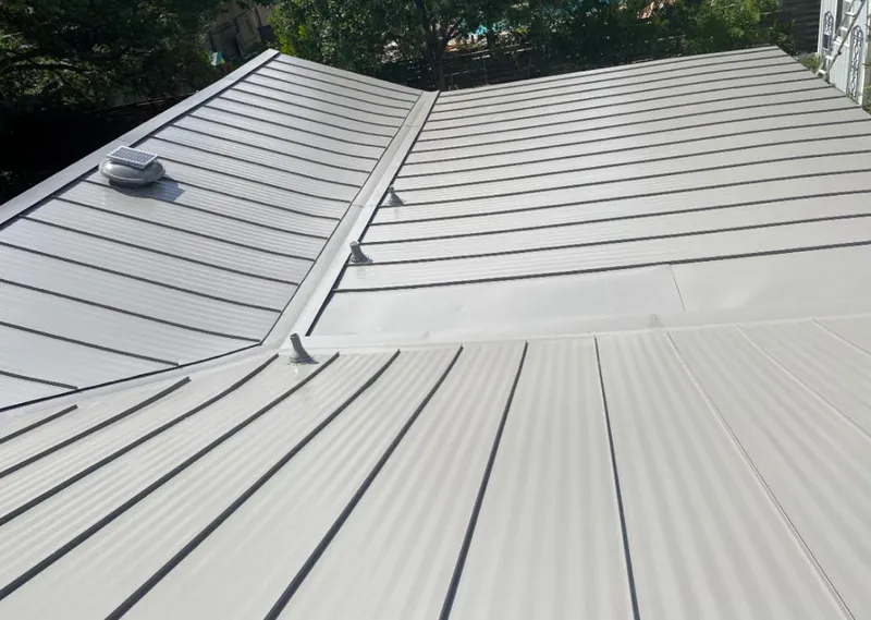 Solar attic fan installed on a metal roof for Roof Ventilation in Forest City